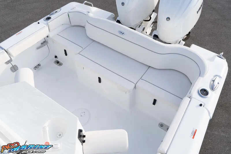 Slide: The Image of 2026 Sea Hunt Ultra 265 SE boat interior with white seating and dual engines. - 20