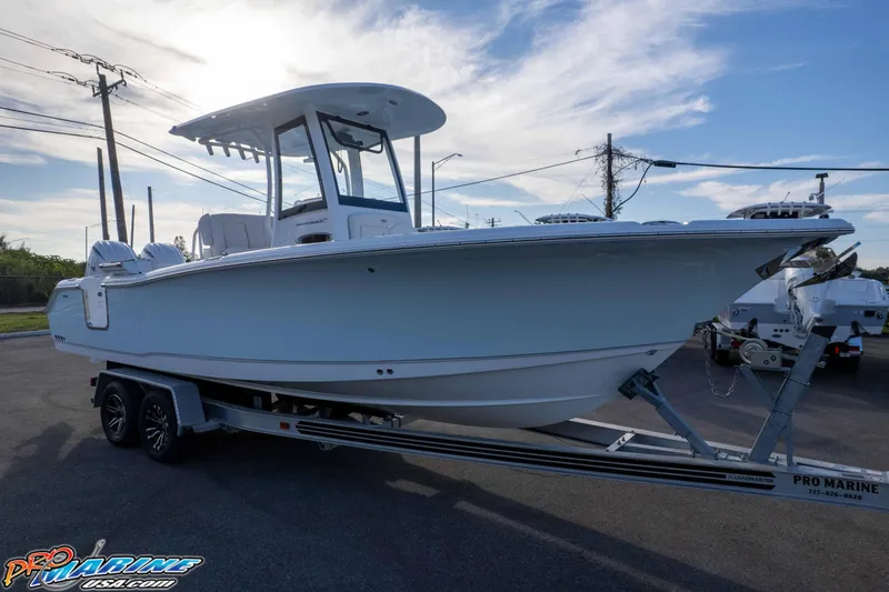 Slide: The Image of 2026 Sea Hunt Ultra 265 SE boat on trailer under clear sky. - 21