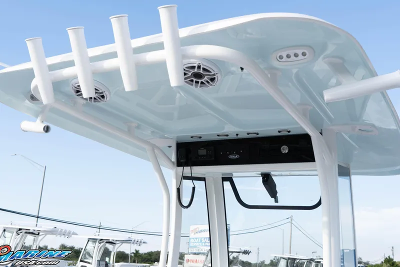 Slide: The Image of T-top of 2026 Sea Hunt Ultra 265 SE boat with rod holders and speakers. - 23