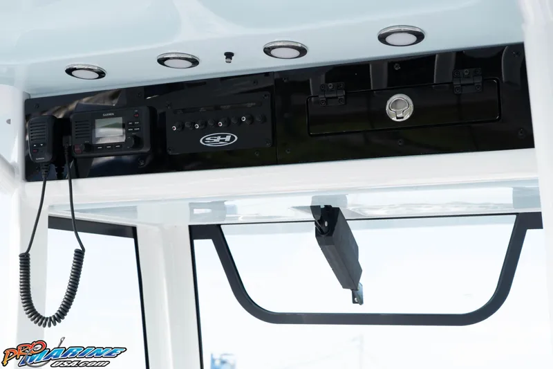 Slide: The Image of 2026 Sea Hunt Ultra 265 SE boat console with Garmin radio and control panel. - 25