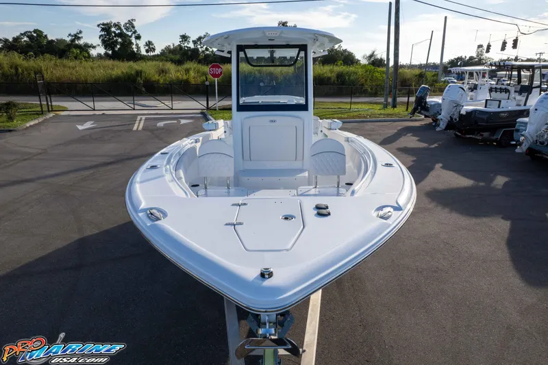 Slide: The Image of 2026 Sea Hunt Ultra 265 SE boat displayed in a parking lot, front view. - 27