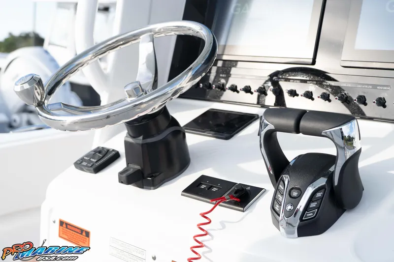 Slide: The Image of Steering console of 2026 Sea Hunt Ultra 265 SE boat with modern controls. - 28