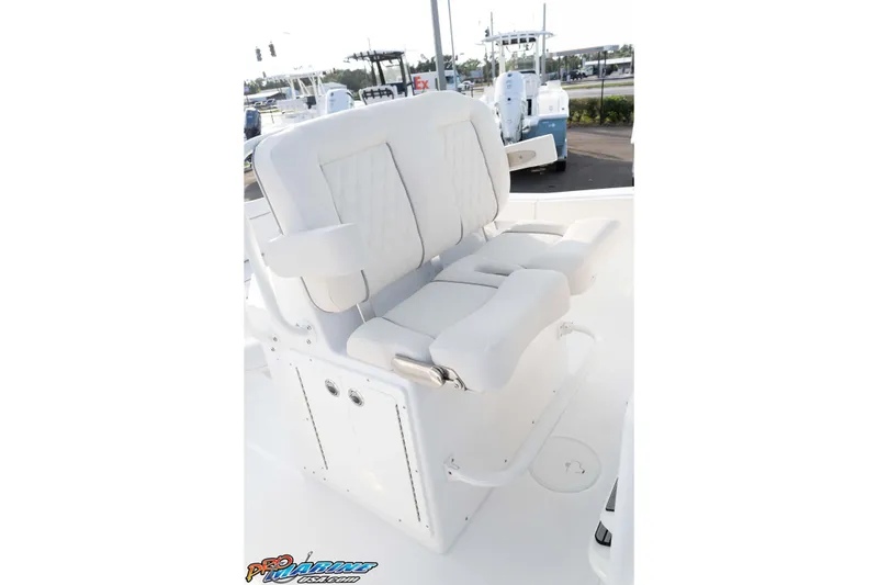 Slide: The Image of 2026 Sea Hunt Ultra 265 SE boat seating, featuring plush white upholstery and armrests. - 31