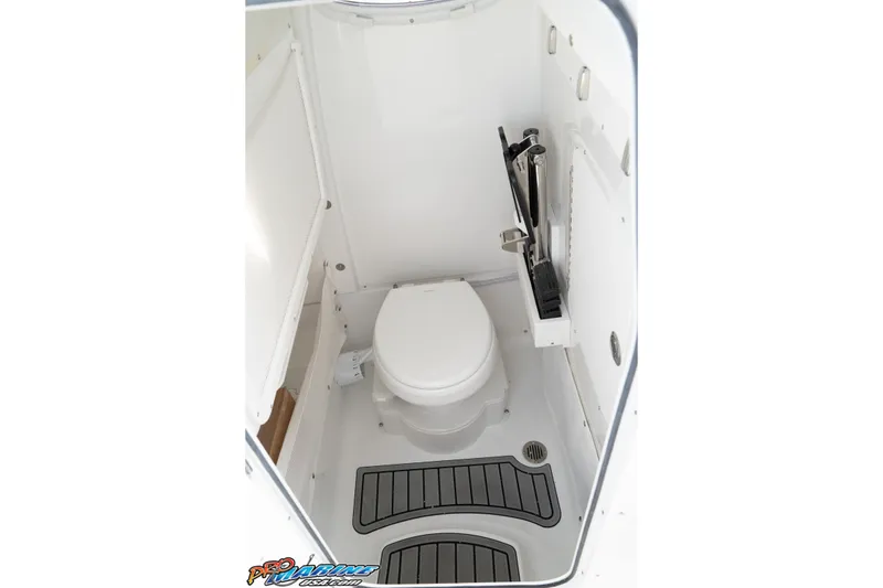 Slide: The Image of 2026 Sea Hunt Ultra 265 SE boat interior bathroom with toilet and storage. - 33
