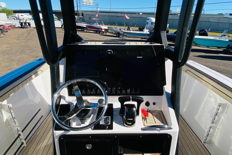 Slide: The Image of 2023 Yamaha Boats 255 FSH Sport E dashboard with steering wheel and controls. - 7