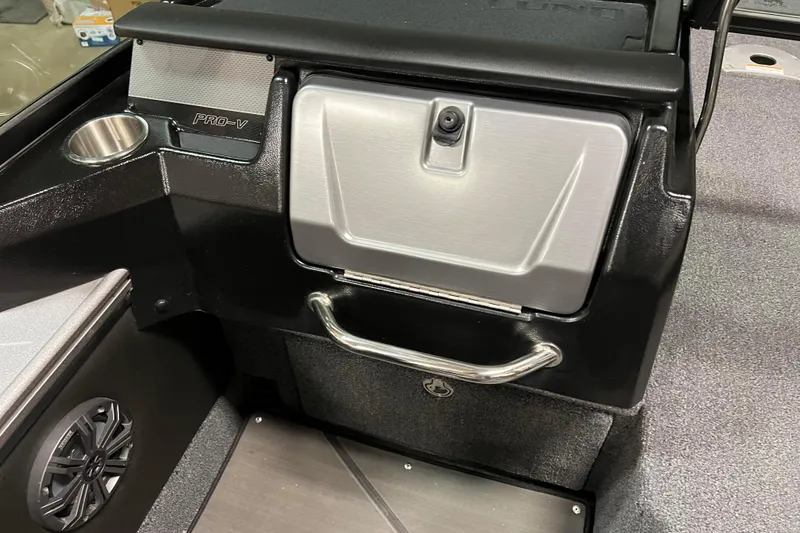 Slide: The Image of 2023 Lund 2175 Pro-V boat interior with storage compartment and speaker. - 14