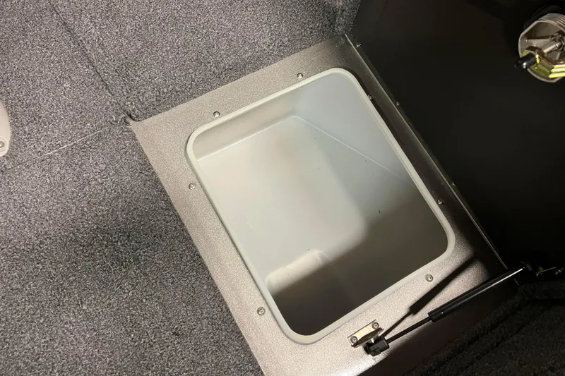 Slide: The Image of 2023 Lund 2175 Pro-V boat storage compartment with open lid, showcasing interior space. - 19