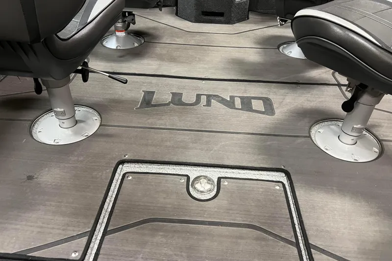 Slide: The Image of 2023 Lund 2175 Pro-V boat interior with logo and seating. - 28