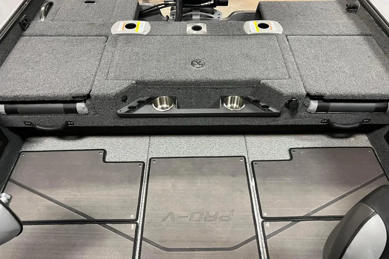 Slide: The Image of 2023 Lund 2175 Pro-V boat interior with storage compartments and cup holders. - 30