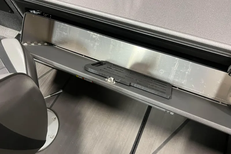 Slide: The Image of 2023 Lund 2175 Pro-V boat interior storage compartment with seat and floor view. - 34