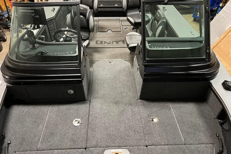 Slide: The Image of 2023 Lund 2175 Pro-V boat interior with seating and steering console. - 39