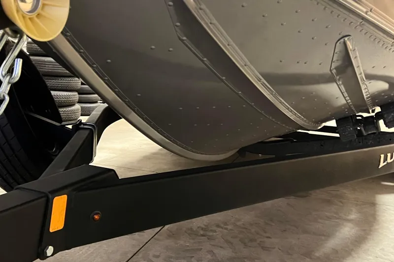 Slide: The Image of 2023 Lund 2175 Pro-V boat on trailer, close-up view of hull and frame. - 48