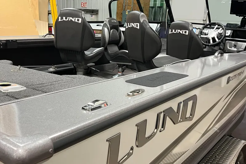 Slide: The Image of 2023 Lund 2175 Pro-V boat interior with branded seats and sleek design. - 59