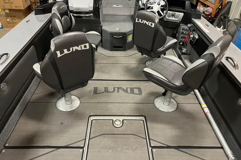 Slide: The Image of 2023 Lund 2175 Pro-V boat interior with branded seating and sleek design. - 6