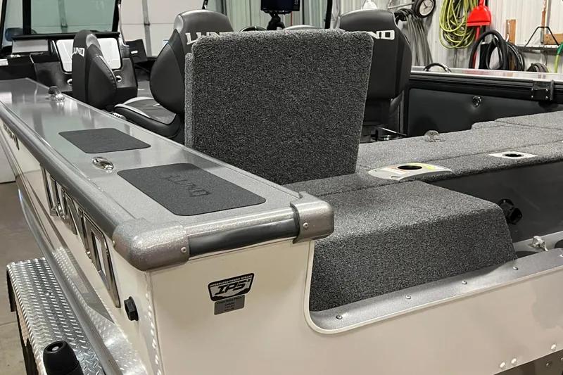 Slide: The Image of 2023 Lund 2175 Pro-V boat interior with seating and storage compartments. - 63