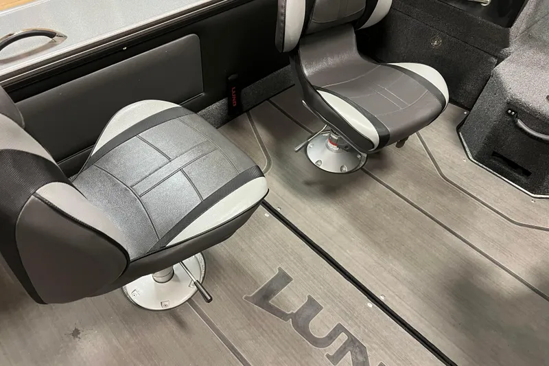 Slide: The Image of 2023 Lund 2175 Pro-V boat interior with two swivel seats and branded flooring. - 7
