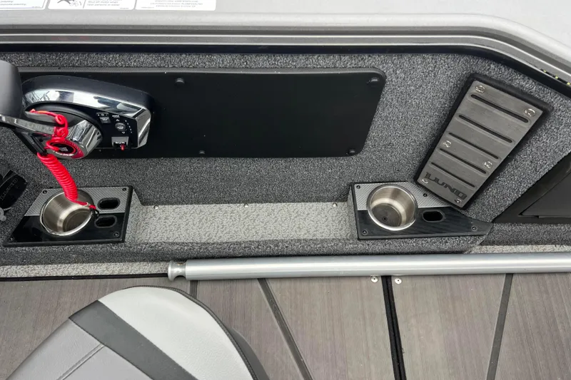 Slide: The Image of 2023 Lund 2175 Pro-V boat interior with control panel and cup holders. - 75