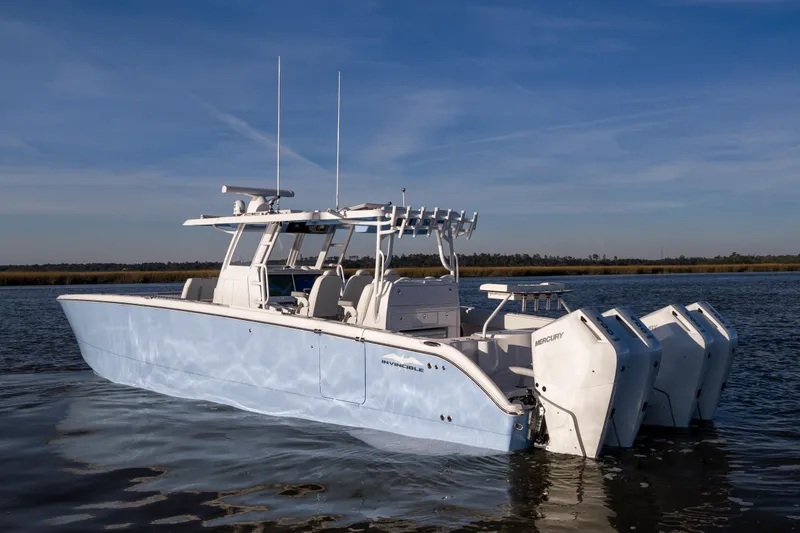 Slide: The Image of 2024 Invincible 40 Catamaran on water, featuring multiple outboard engines, sleek design. - 1