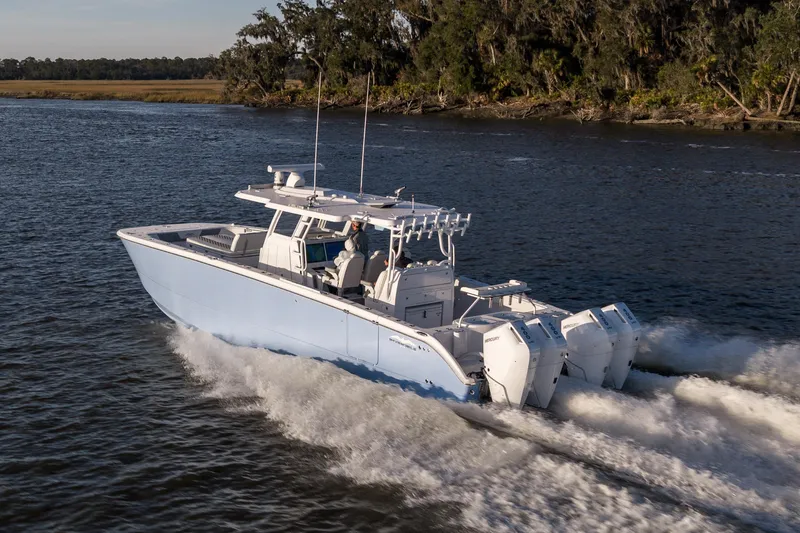 Slide: The Image of 2024 Invincible 40 Catamaran cruising on a scenic waterway. - 12