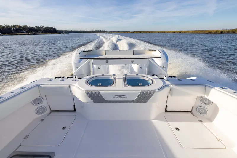 Slide: The Image of 2024 Invincible 40 Catamaran cruising on open water, showcasing sleek design and powerful engines. - 17