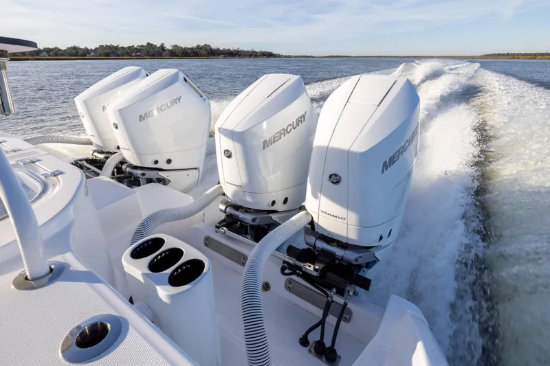 Slide: The Image of 2024 Invincible 40 Catamaran with powerful Mercury outboard engines on open water. - 18