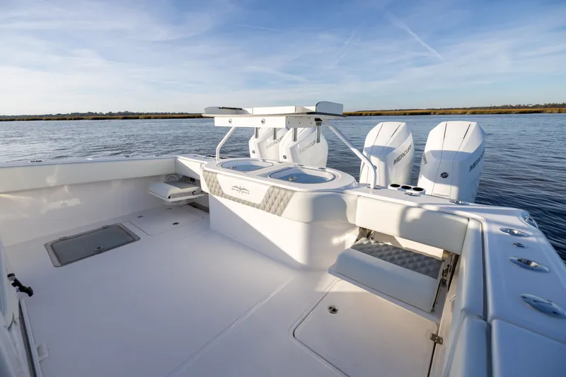 Slide: The Image of 2024 Invincible 40 Catamaran boat deck with dual engines on calm water. - 20