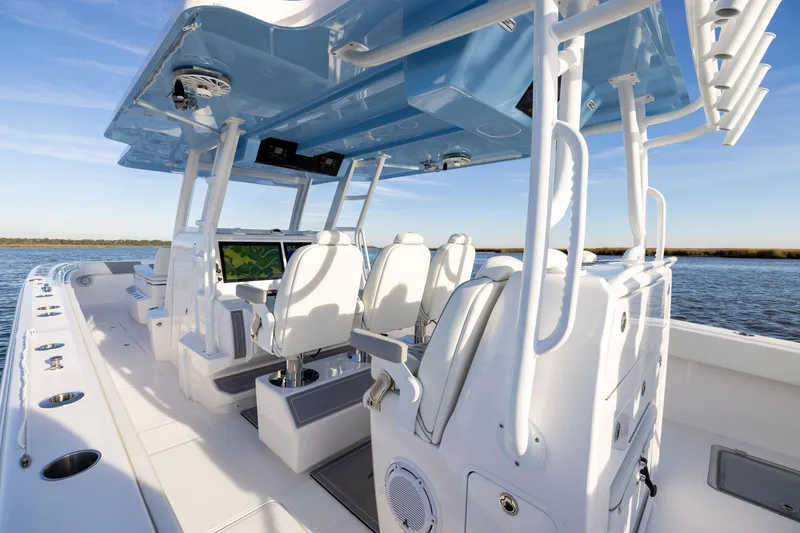 Slide: The Image of 2024 Invincible 40 Catamaran interior with modern seating and navigation system on open water. - 29