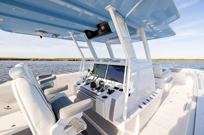 Slide: The Image of 2024 Invincible 40 Catamaran interior with modern helm and seating on open water. - 30