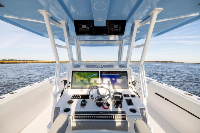 Slide: The Image of 2024 Invincible 40 Catamaran helm with dual displays on open water. - 32