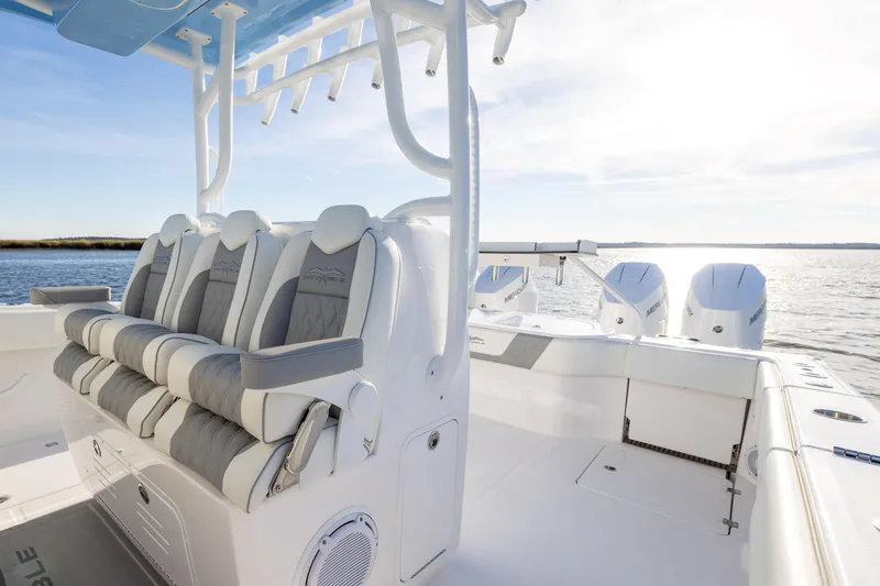 Slide: The Image of 2024 Invincible 40 Catamaran interior with luxurious seating and powerful engines on open water. - 44