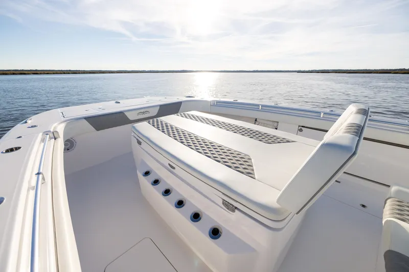 Slide: The Image of 2024 Invincible 40 Catamaran deck with seating, overlooking serene water. - 49