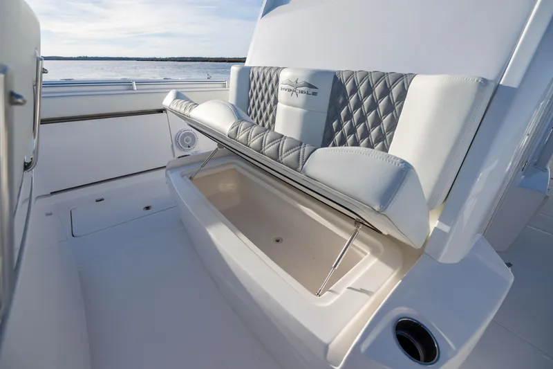 Slide: The Image of 2024 Invincible 40 Catamaran seat with storage compartment, featuring quilted upholstery. - 53