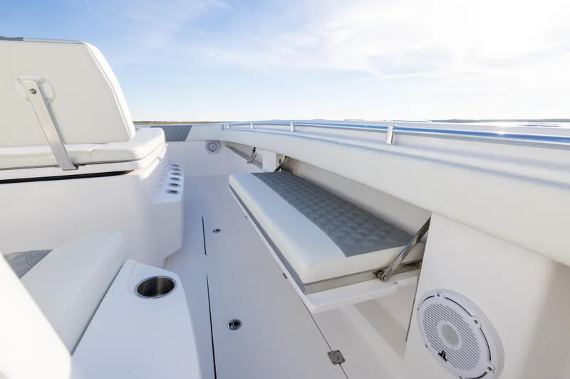 Slide: The Image of 2024 Invincible 40 Catamaran interior with cushioned seating and cup holder. - 54