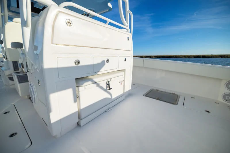 Slide: The Image of 2024 Invincible 40 Catamaran interior with storage compartments, under clear blue sky. - 57