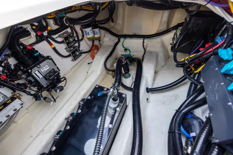 Slide: The Image of Engine compartment of 2024 Invincible 40 Catamaran, showcasing wiring and components. - 63