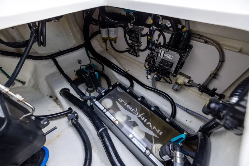 Slide: The Image of Engine compartment of 2024 Invincible 40 Catamaran, showcasing wiring and components. - 65
