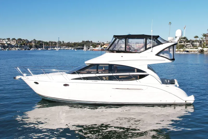 The Image of 2006 Meridian 391 Sedan yacht on calm water, clear sky background. - 0