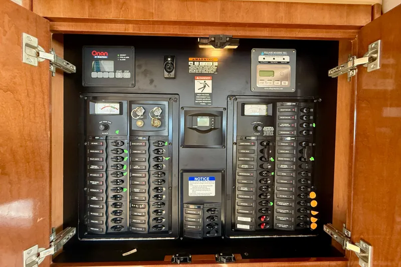 Slide: The Image of Electrical control panel inside 2006 Meridian 391 Sedan boat, featuring various switches and meters. - 13