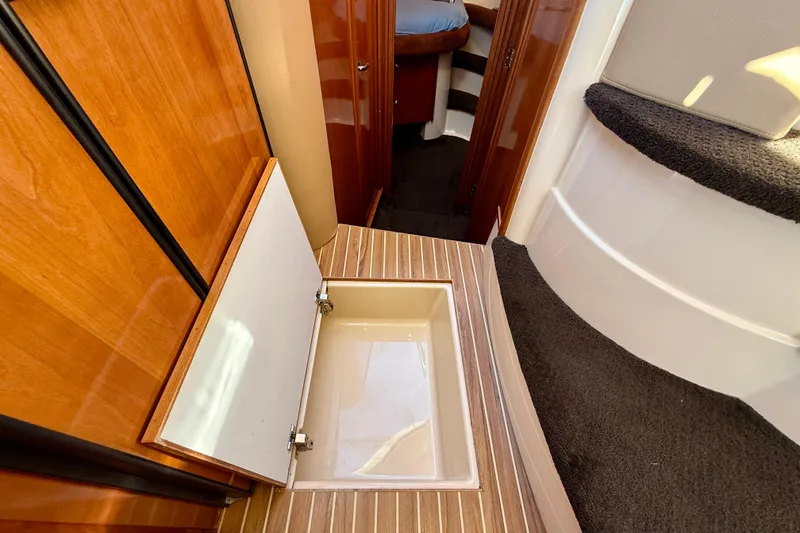 Slide: The Image of 2006 Meridian 391 Sedan interior with open floor storage compartment and wooden finish. - 20