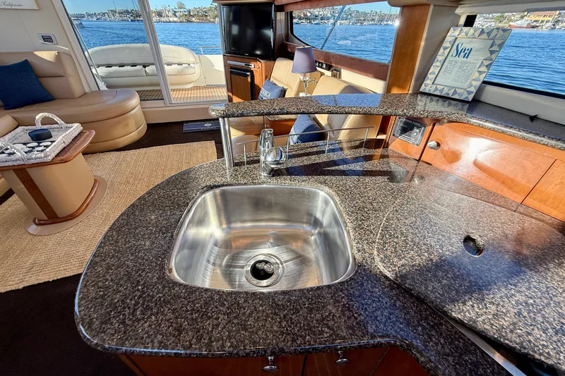 Slide: The Image of Luxurious interior of 2006 Meridian 391 Sedan yacht with granite countertops and scenic water view. - 23
