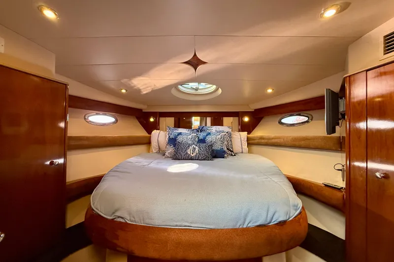 Slide: The Image of Luxurious 2006 Meridian 391 Sedan yacht bedroom with elegant wood finishes and cozy bedding. - 25