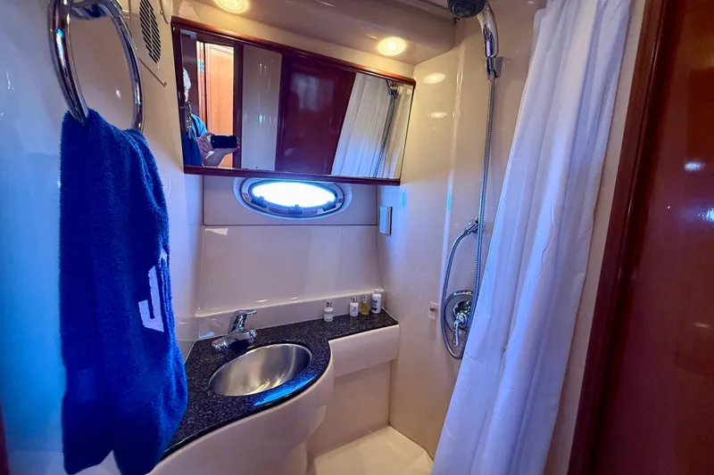 Slide: The Image of Bathroom interior of 2006 Meridian 391 Sedan yacht with sink, shower, and towel. - 29