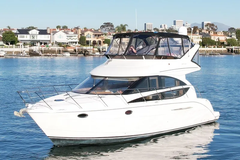 Slide: The Image of 2006 Meridian 391 Sedan yacht cruising in a scenic waterfront area. - 3