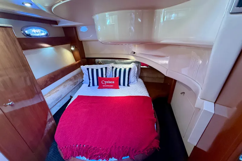Slide: The Image of Cozy bedroom in 2006 Meridian 391 Sedan yacht with red and white bedding. - 31