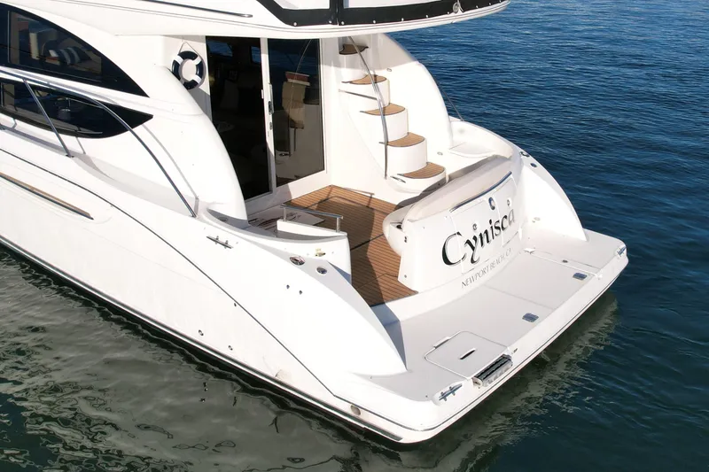 Slide: The Image of 2006 Meridian 391 Sedan yacht on water, rear view with stairs and deck. - 4