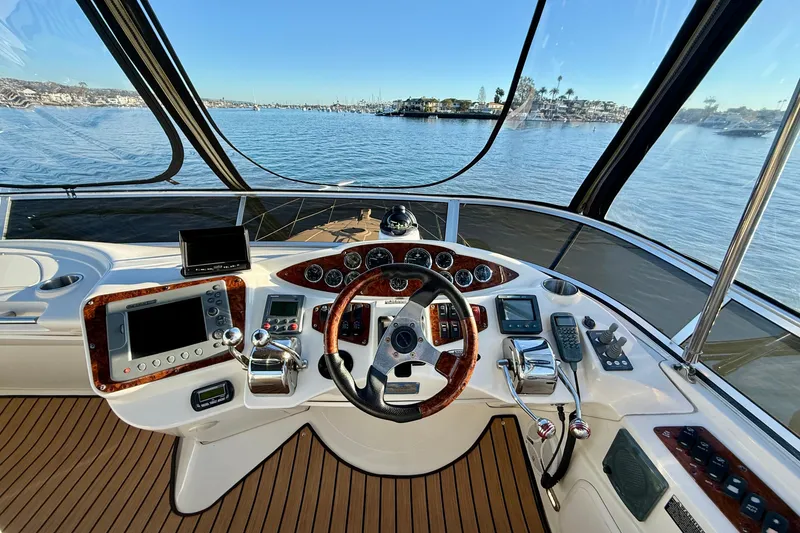 Slide: The Image of 2006 Meridian 391 Sedan helm with navigation controls and scenic water view. - 44
