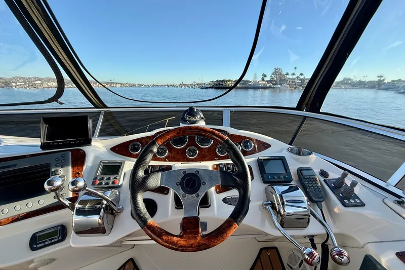 Slide: The Image of Cockpit view of 2006 Meridian 391 Sedan yacht with steering wheel and controls, overlooking marina. - 45