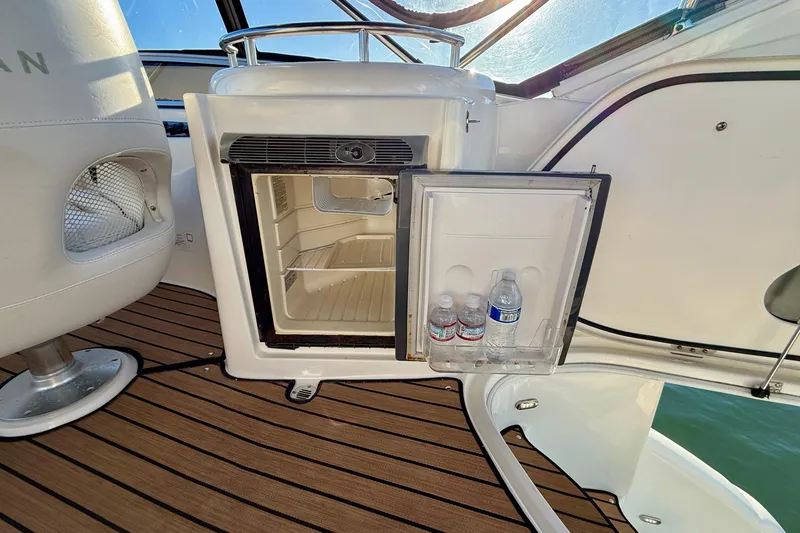 Slide: The Image of Open mini fridge on 2006 Meridian 391 Sedan boat with water bottles inside. - 49