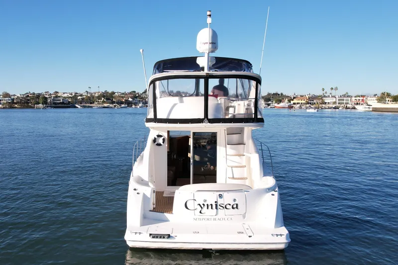 Slide: The Image of 2006 Meridian 391 Sedan yacht on calm water, Newport Beach backdrop. - 5