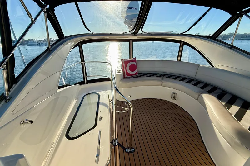 Slide: The Image of Luxurious 2006 Meridian 391 Sedan yacht interior with curved seating and scenic water view. - 52
